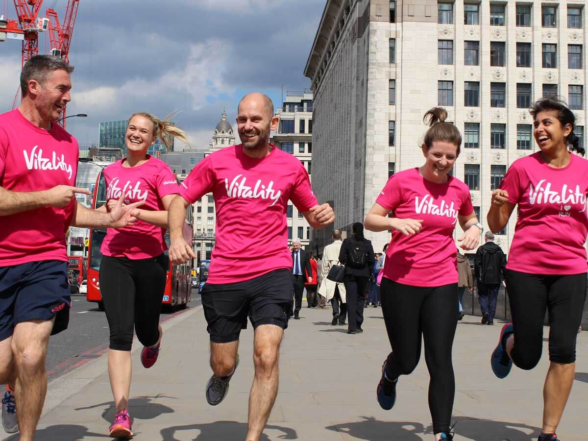 People running in pink Vitality shirts