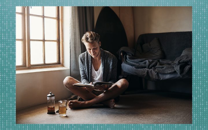 Man sitting on the floor reading a book