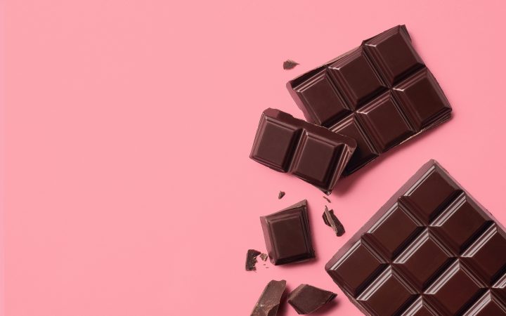 Dark chocolate on pink background