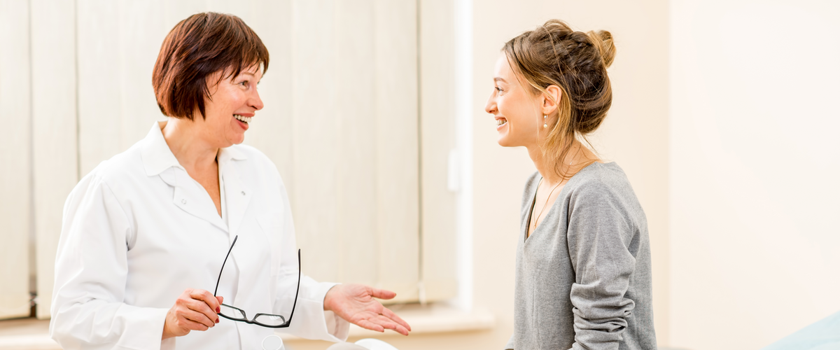 young woman patient with a senior gynecologist during the consultation in the gynecological office